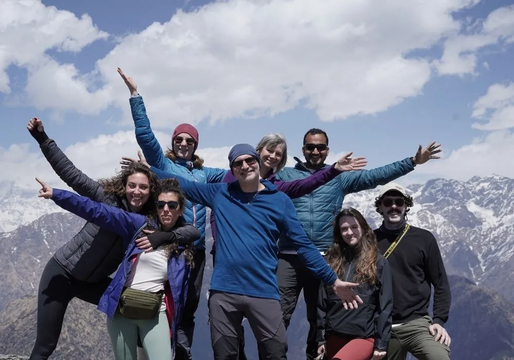 Group of yoga students with panoramic Himalayan mountain view