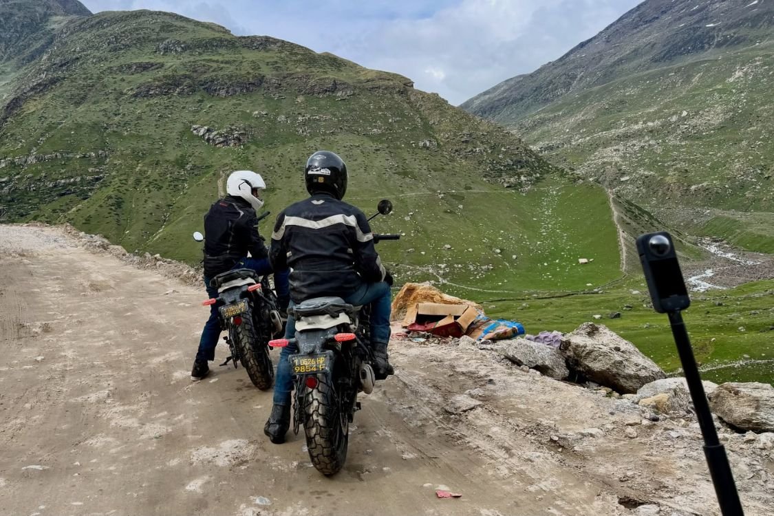Motorcycle riding on a Himalayan mountain road during yoga retreat