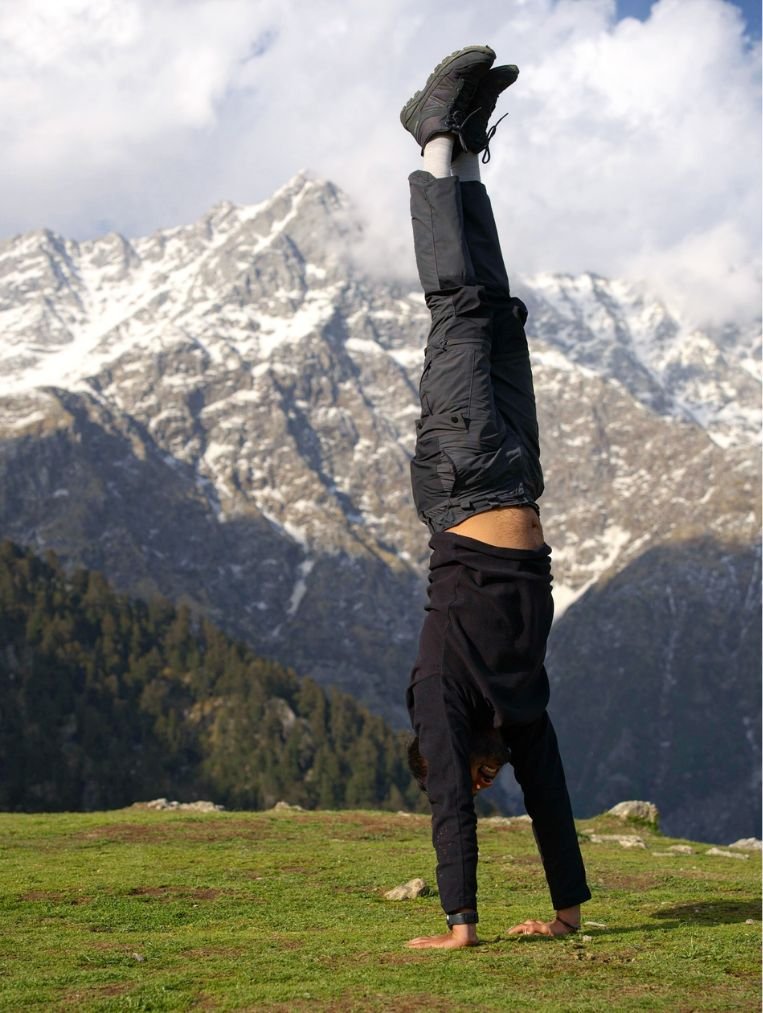 Outdoor yoga session with Himalayan mountain backdrop during bike retreat