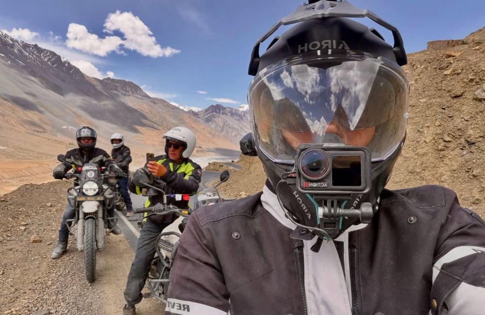 Campers around a bonfire at a Himalayan campsite during bike yoga retreat