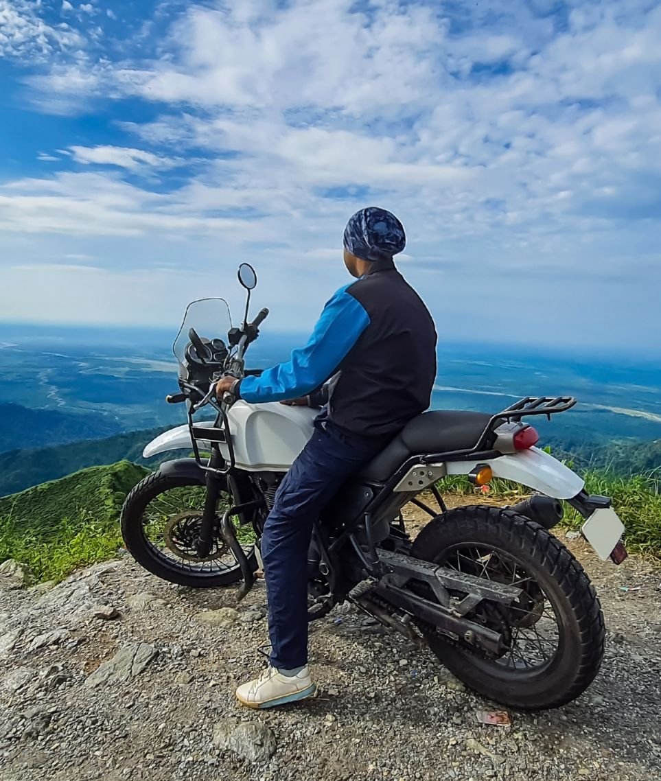 Motorcycles riding a Himalayan mountain road at golden hour